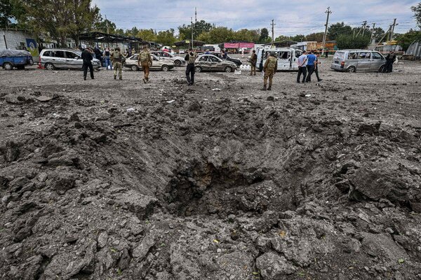 broken-glass,-blown-out-tires-and-a-crater-show-the-violence-of-a-deadly-attack-in-zaporizhzhia.